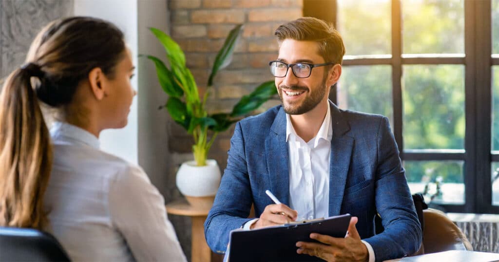 Male professional in one on one meeting taking notes